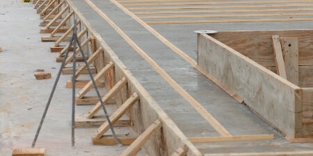 Image of wood forms holding a concrete slab in place while it cures prior to being tilted up
