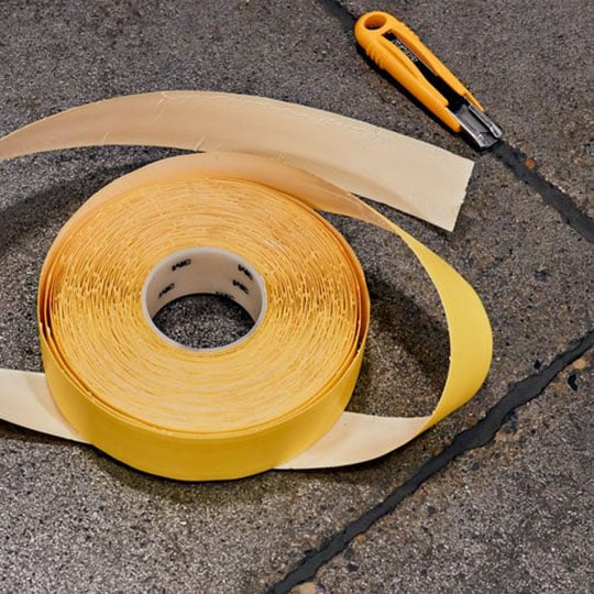 Roll of floor marking tape along with boxcutter