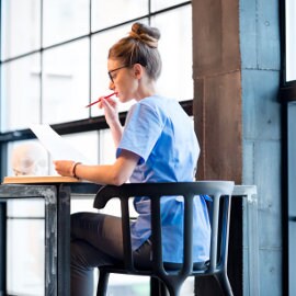 Woman reading a document at a desk