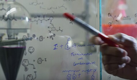 Scientific equations written on a whiteboard

