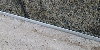 Sealed expansion joint between two materials that expand and contract at different rates
