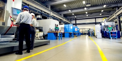 Image of a factory floor with yellow tape marking off a travel lane
