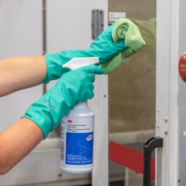 3M glass cleaner in use on glass door