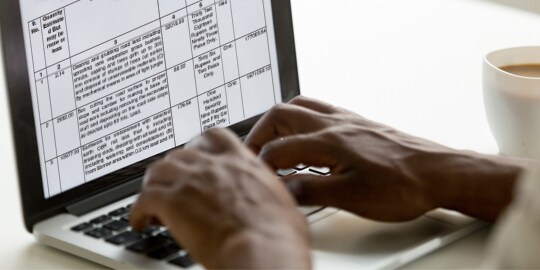 Hands typing on a keyboard.
