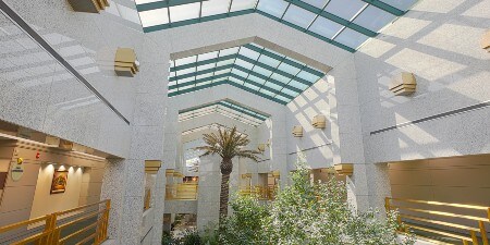 Image of a large room under a glass-paneled roof
