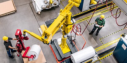 Aerial shot of two people working inside facility
