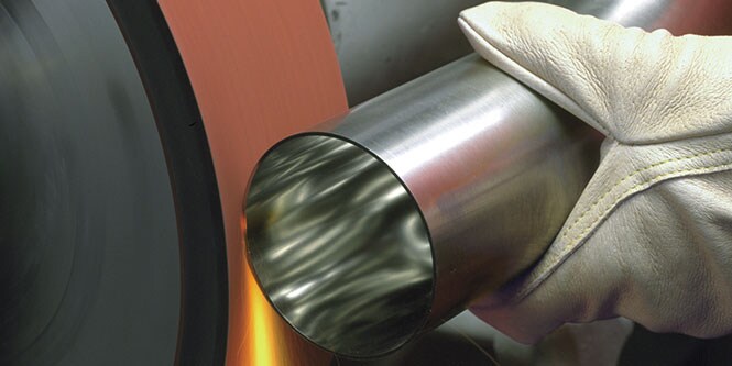 image of hand holding metal to a belt
