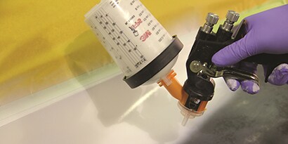 accuspray spray gun equipped with PPS applying primer to new part
