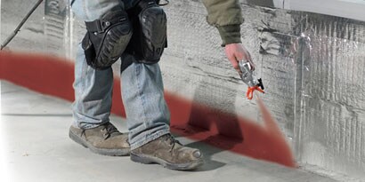 Person applying firestopping product to wall
