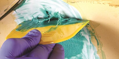 applying fiberglass resin to repair area
