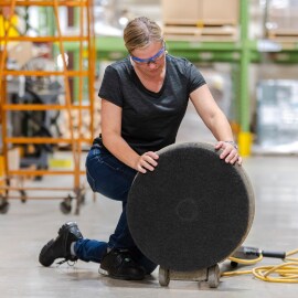 Person prepping and applying stripper pad