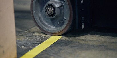 Machine rolling over floor tape
