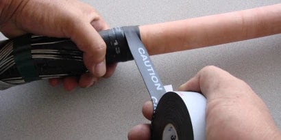 Worker wrapping power cable with 3M Electrical Conducting Tape 13
