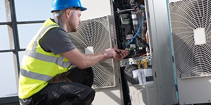 man working on electrical junction box
