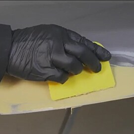 worker doing large damage panel repair