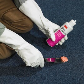 Person removing gum from carpet with 3M Gum Remover