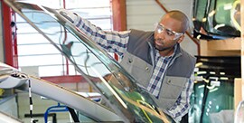 glass technician installing windshield on a vehicle