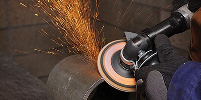 Flap disc beveling a metal edge
