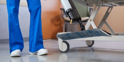 close up of feet on health care facility floor next to gurney

