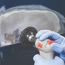 using a Scotch-Brite Clean and Strip abrasive disc on automobile
