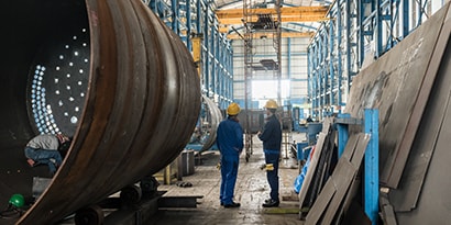 Two people inside of manufacturing facility
