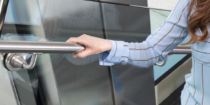 hand resting on cleaning facility stair railing
